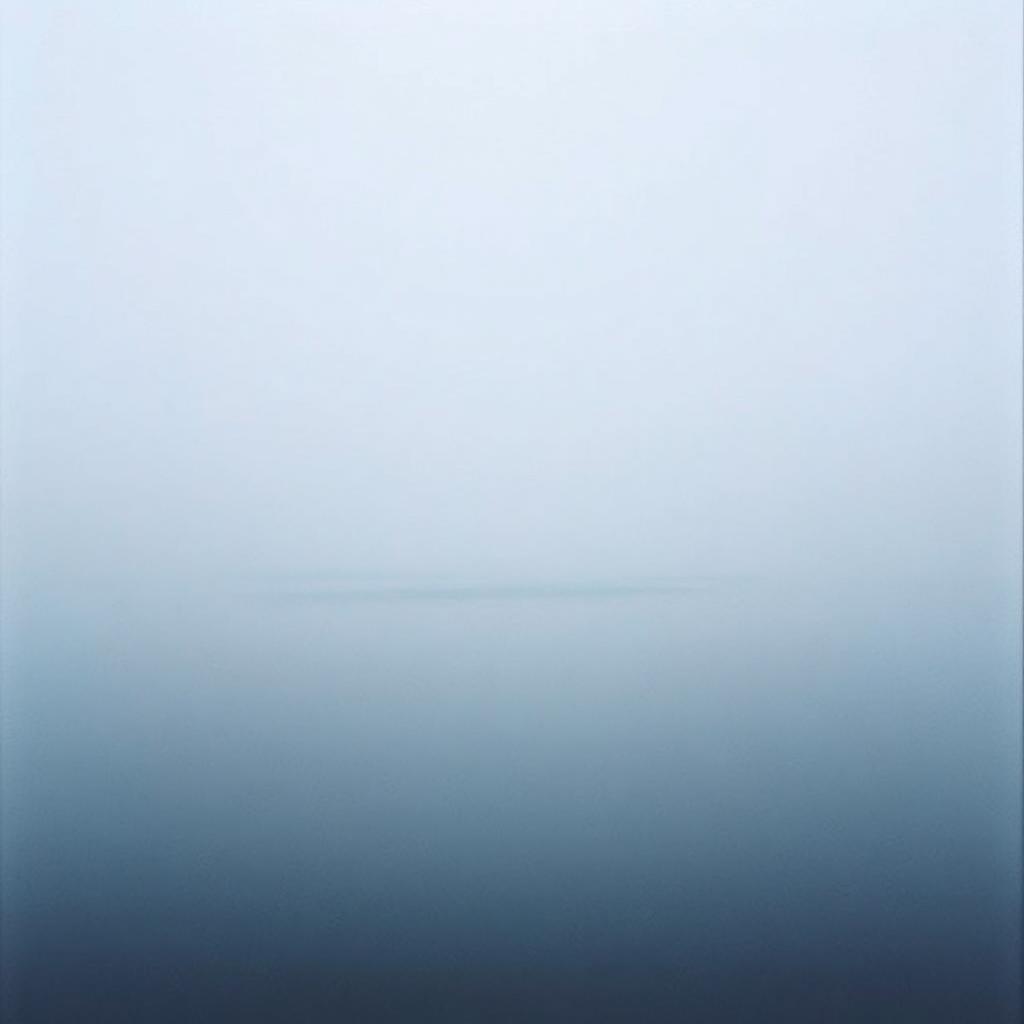 A perfectly still lake at dawn with soft mist on the surface.